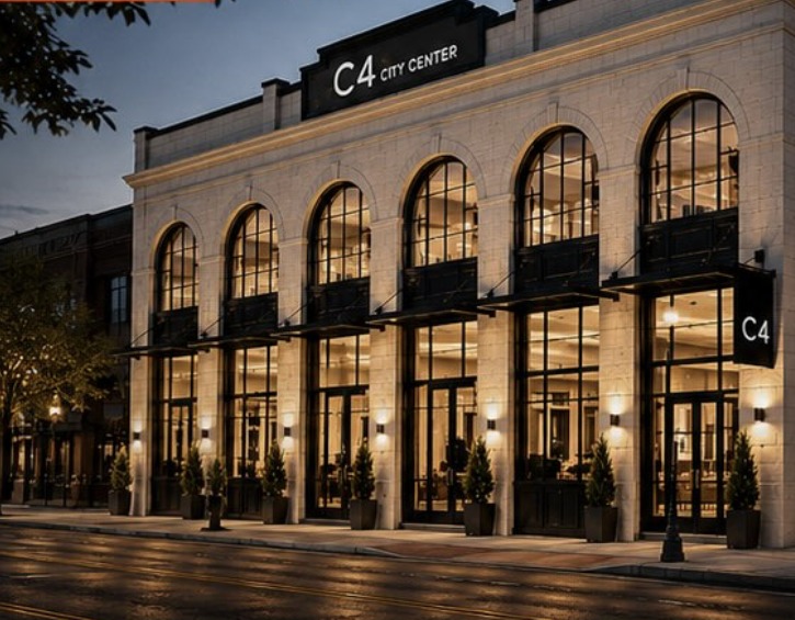 Rendering of the restored C4 City Center with lit arched glass windows on Fourth Street
