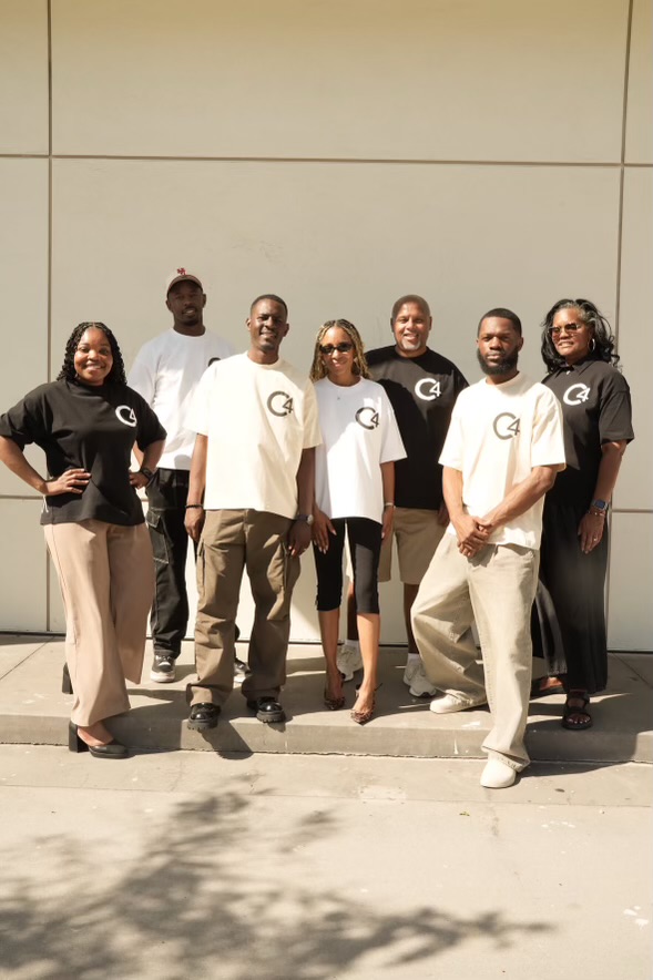 Eight people wearing C4 logo tees outside