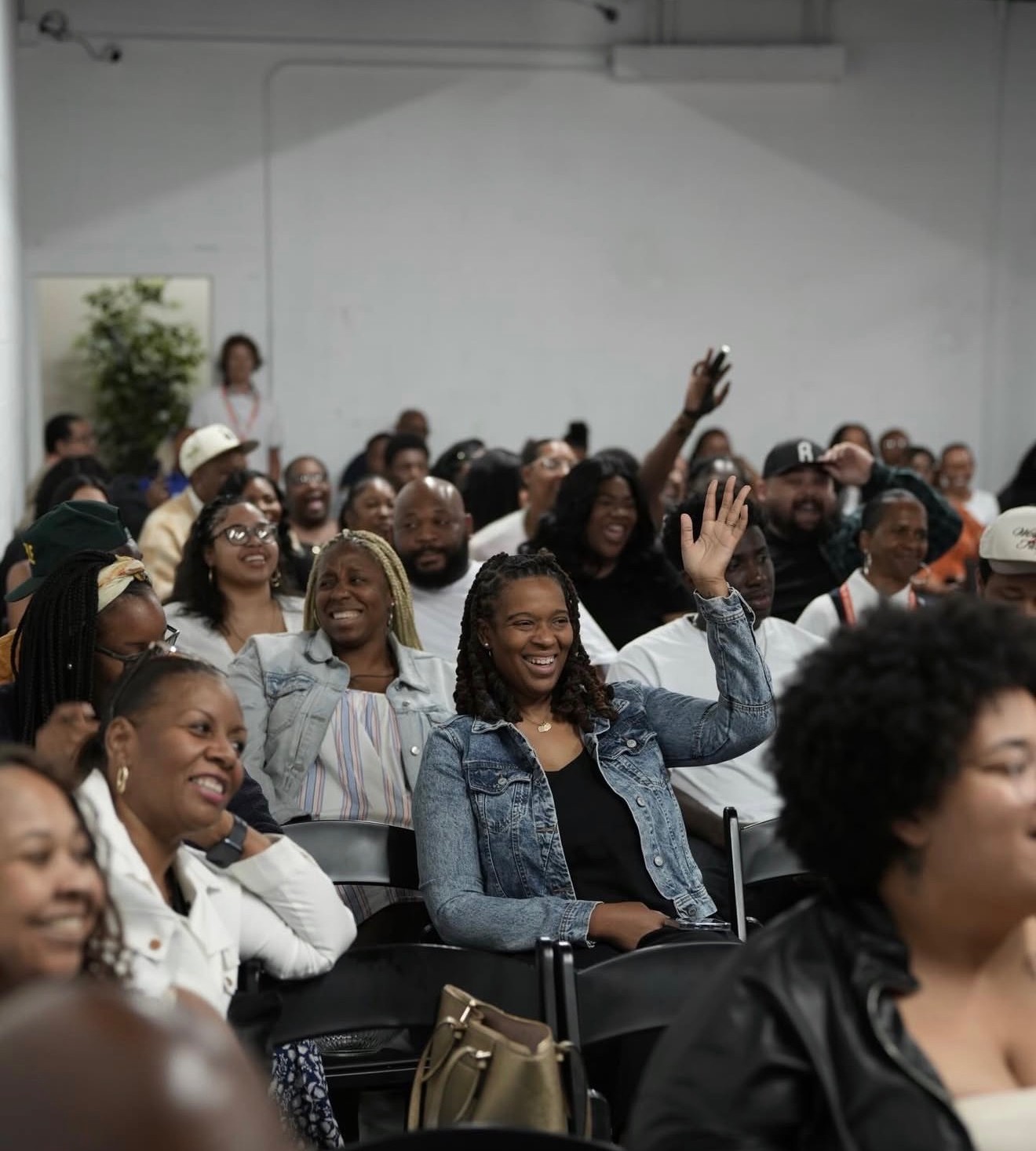 The C4 congregation smiling and raising hands during a Sunday Gathering