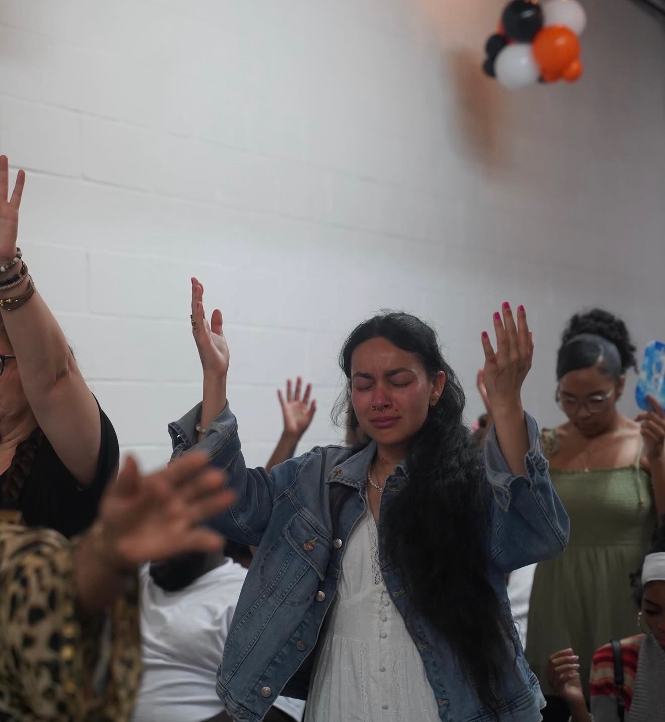 A woman worshipping with her hands lifted at a C4 Gathering